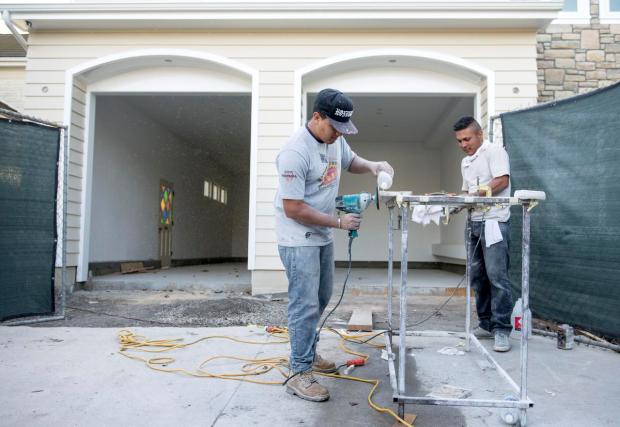 a & j home remodeling crew working on a house job site.